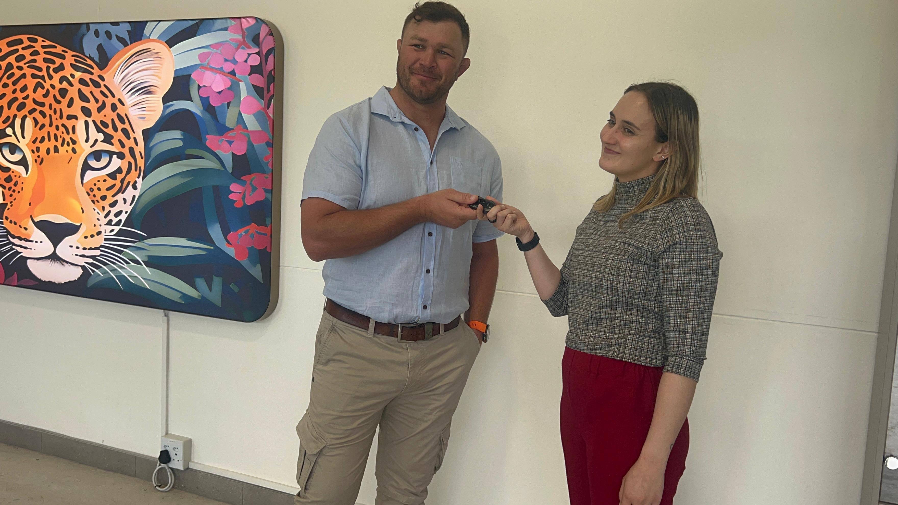 Duane Vermeulen and a woman holding a vehicle key during BMG’s marketing campaign